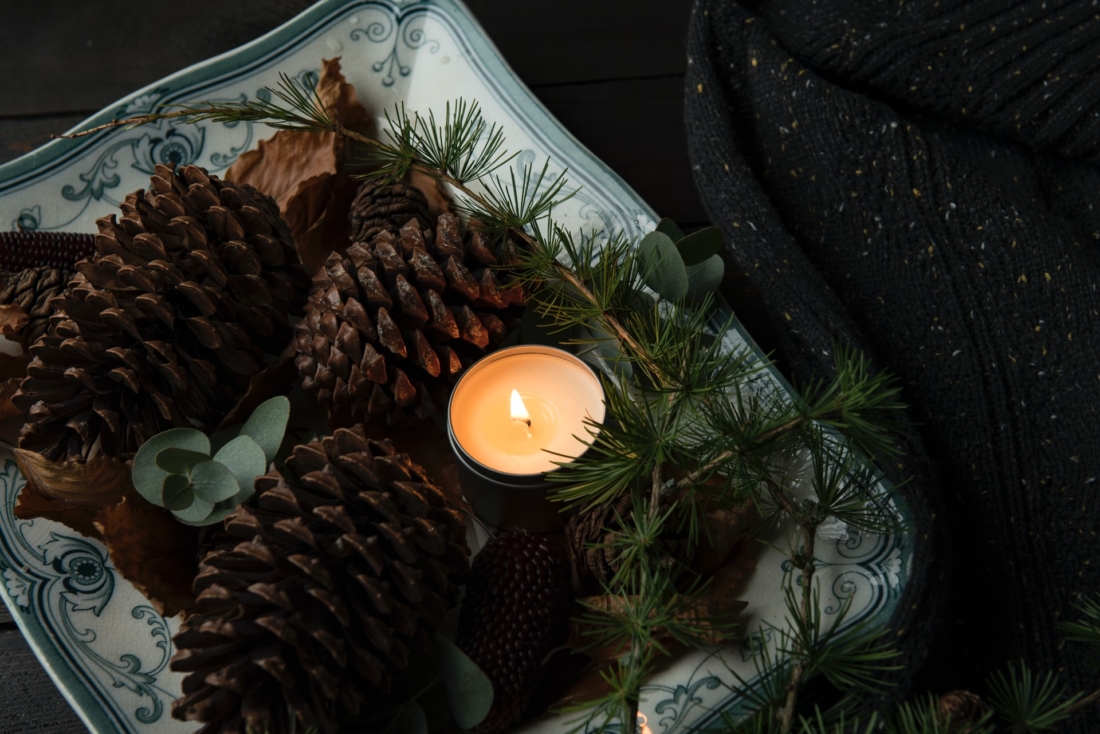 candle and pinecones